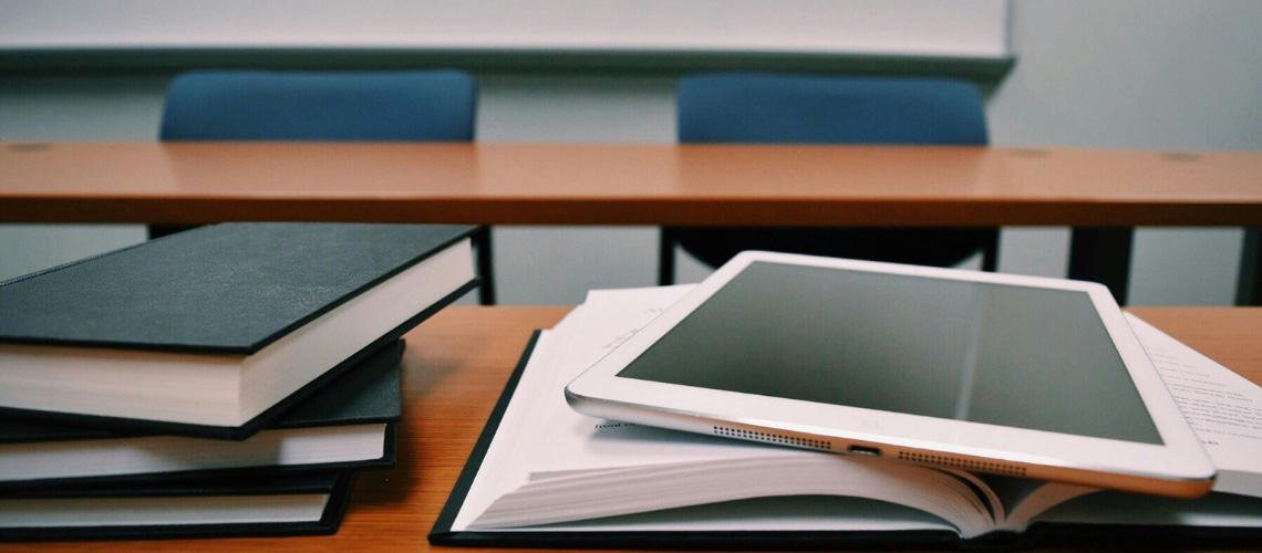 An ipad on an open book