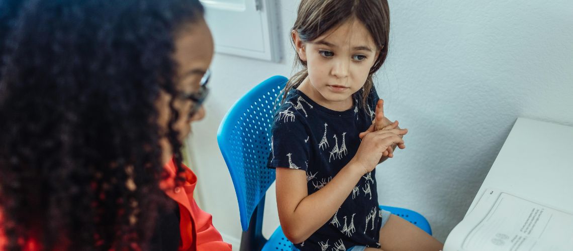 Mother and child sat at a desk
